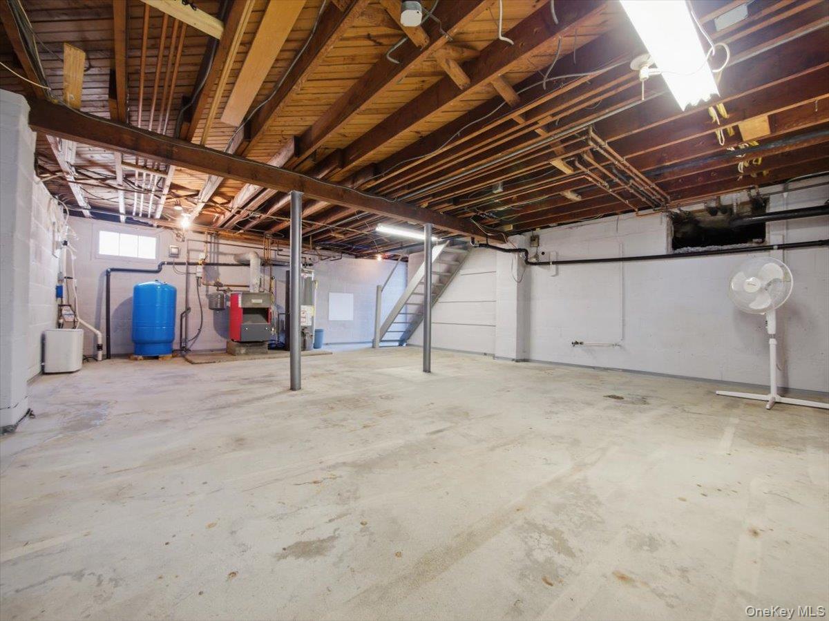 311 Gate Hill Coop Road Stony Point, NY 10980 - Photo 32 of 42 The property features an unfinished basement with exposed wooden beams, concrete flooring, and white block walls