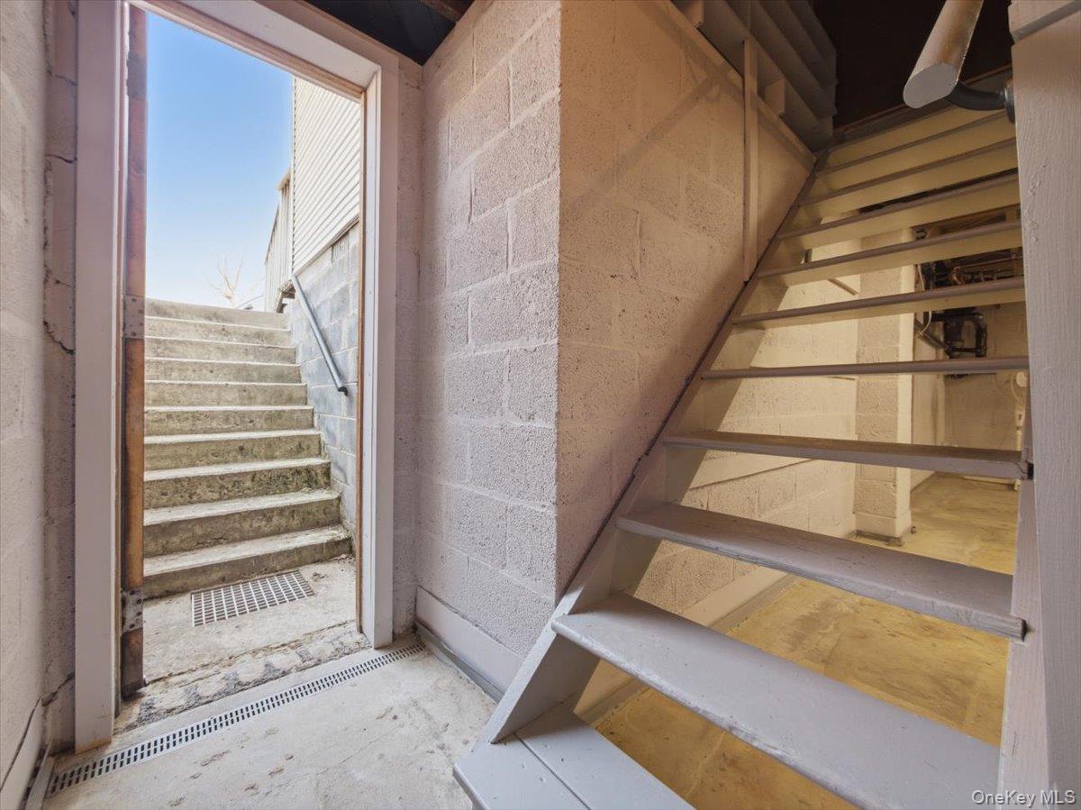 311 Gate Hill Coop Road Stony Point, NY 10980 - Photo 33 of 42 The property features a utility area with concrete block walls and stairs leading to an exterior door