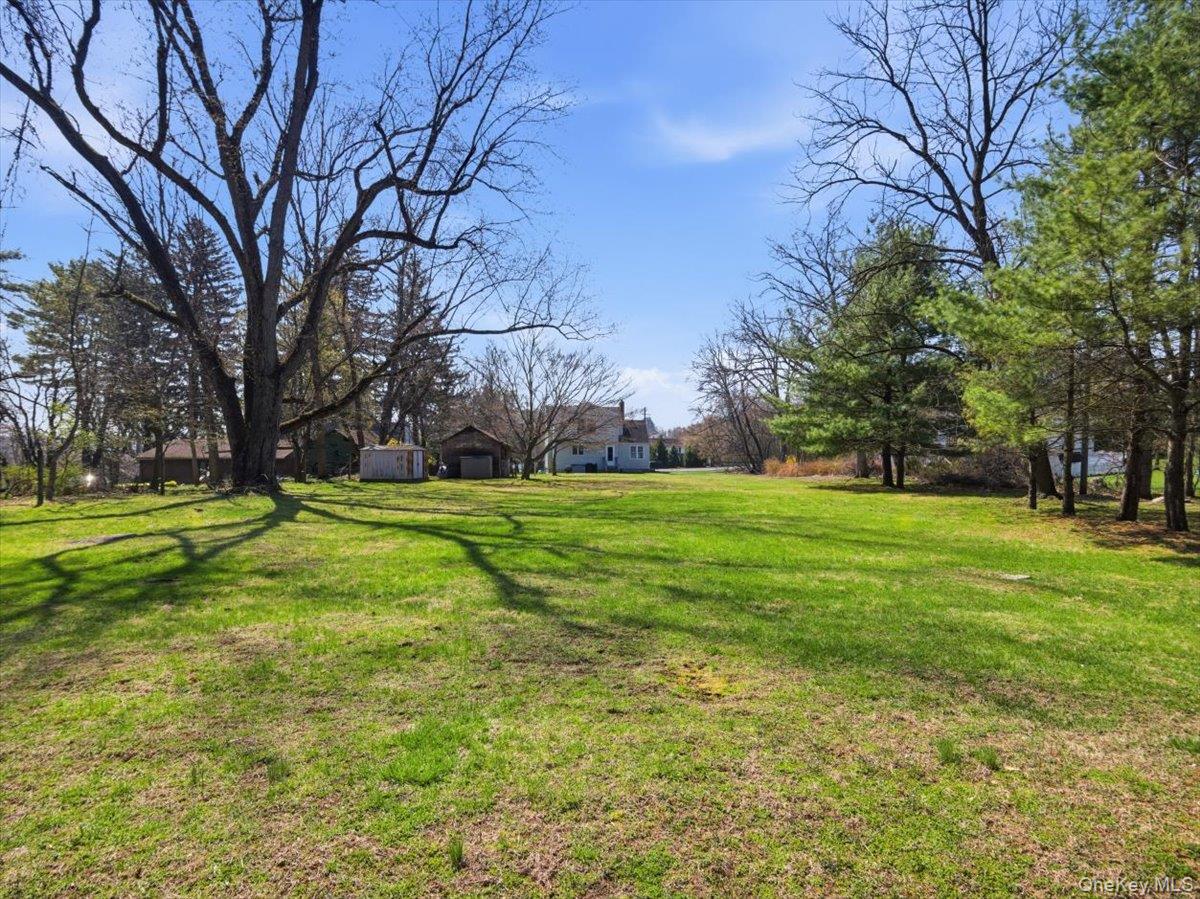 311 Gate Hill Coop Road Stony Point, NY 10980 - Photo 35 of 42 The property features a spacious lawn with mature trees and a clear blue sky overhead