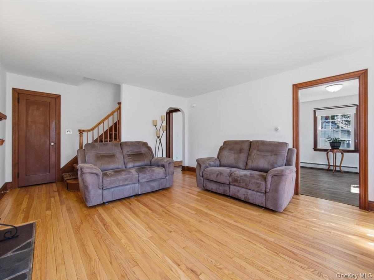 311 Gate Hill Coop Road Stony Point, NY 10980 - Photo 8 of 42 This inviting living space features warm hardwood floors, white walls, and rich wood trim around the doorways and staircase