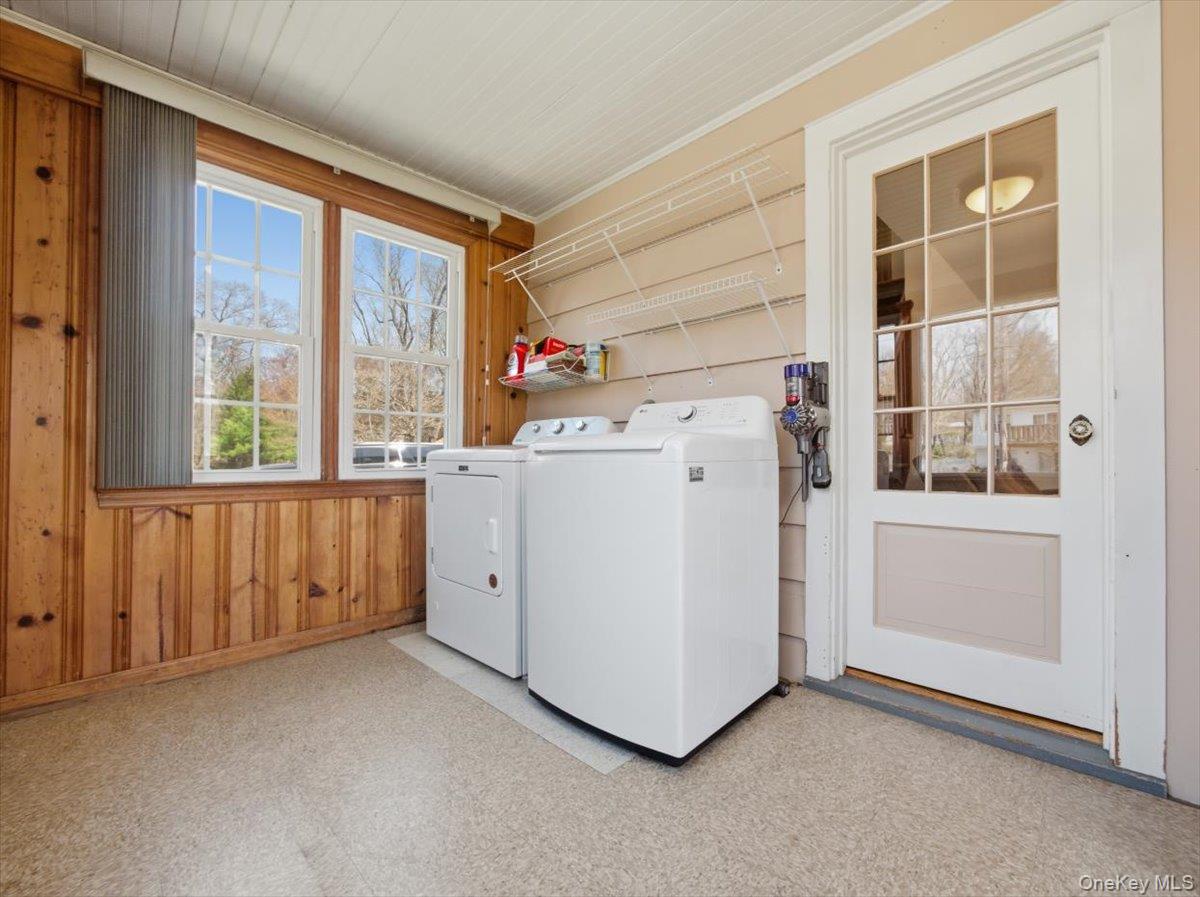 311 Gate Hill Coop Road Stony Point, NY 10980 - Photo 10 of 42 This utility space features two windows, wood paneling, and a white paneled door with glass inserts