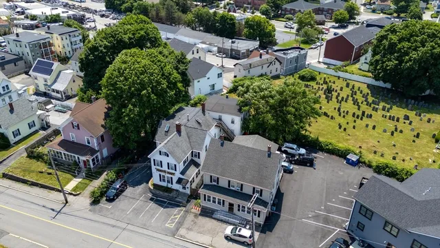 an aerial view of a house with garden space and street view