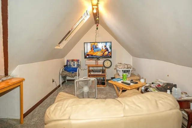 a kitchen with stainless steel appliances a stove and white cabinets