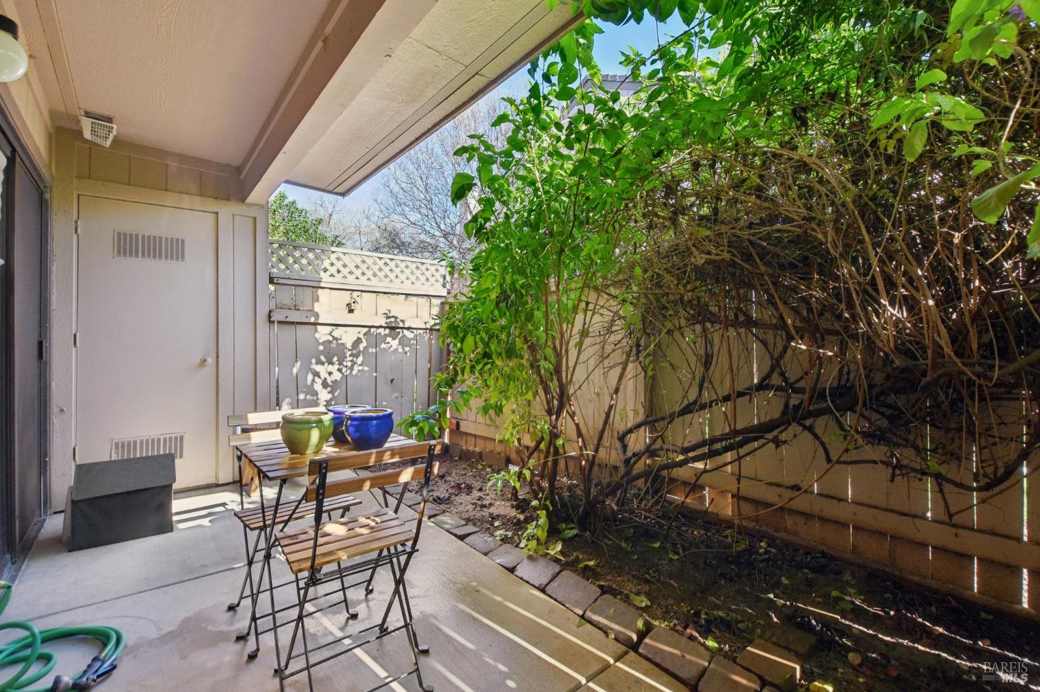 1801 Marshall Road, Unit 401 Vacaville, CA 95687 - Photo 14 of 20 a view of a patio with table and chairs and potted plants