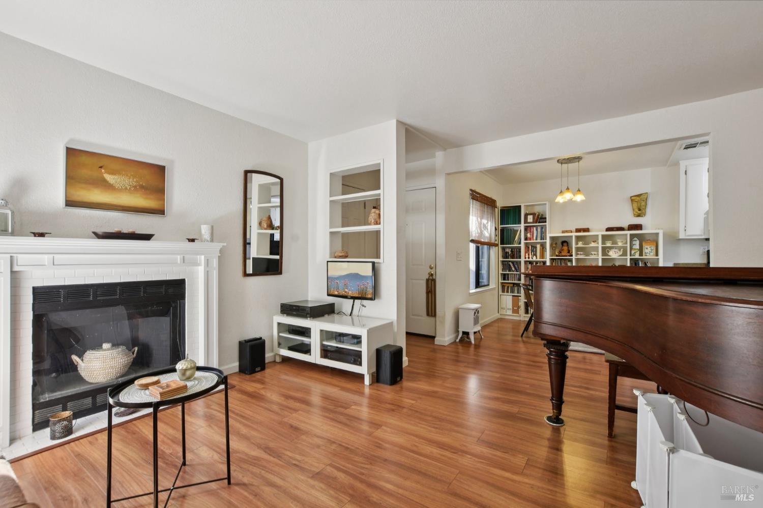 1801 Marshall Road, Unit 401 Vacaville, CA 95687 - Photo 3 of 20 a living room with furniture a fireplace and kitchen view