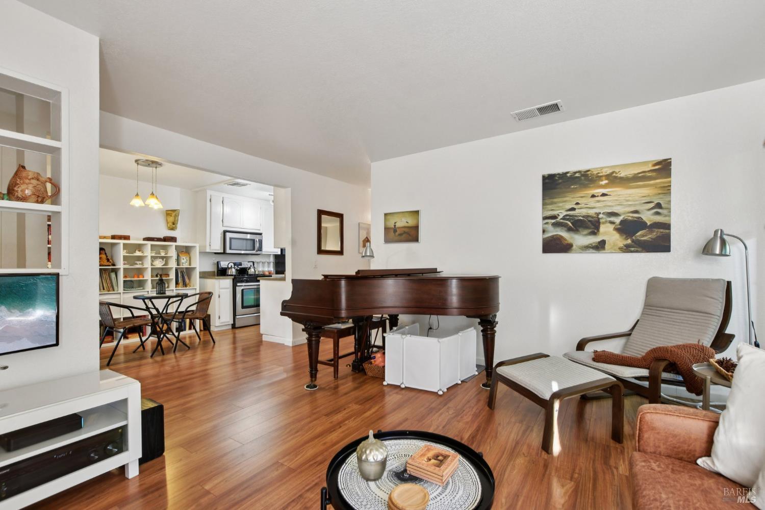 1801 Marshall Road, Unit 401 Vacaville, CA 95687 - Photo 4 of 20 a workspace with furniture a rug and wooden floor