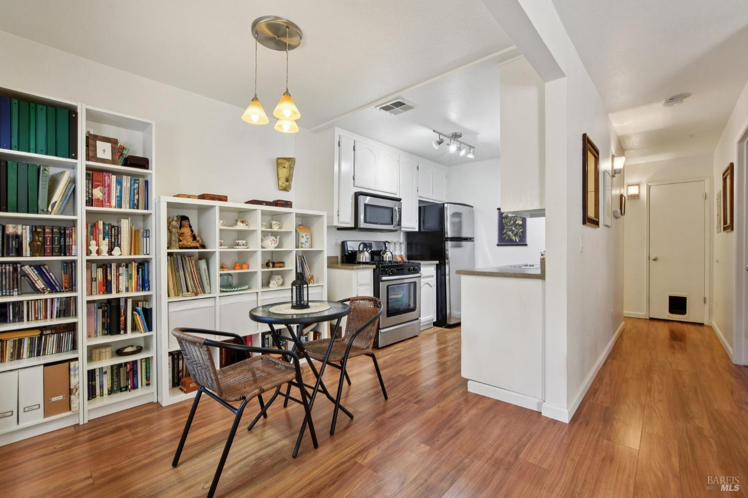 1801 Marshall Road, Unit 401 Vacaville, CA 95687 - Photo 5 of 20 a view of a dining room with furniture a rug and wooden floor