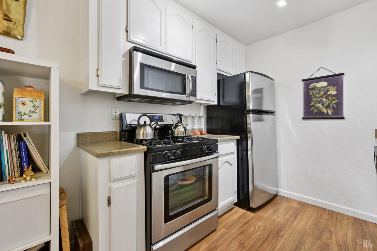 1801 Marshall Road, Unit 401 Vacaville, CA 95687 - Photo 7 of 20 a kitchen with stainless steel appliances a stove a microwave and cabinets