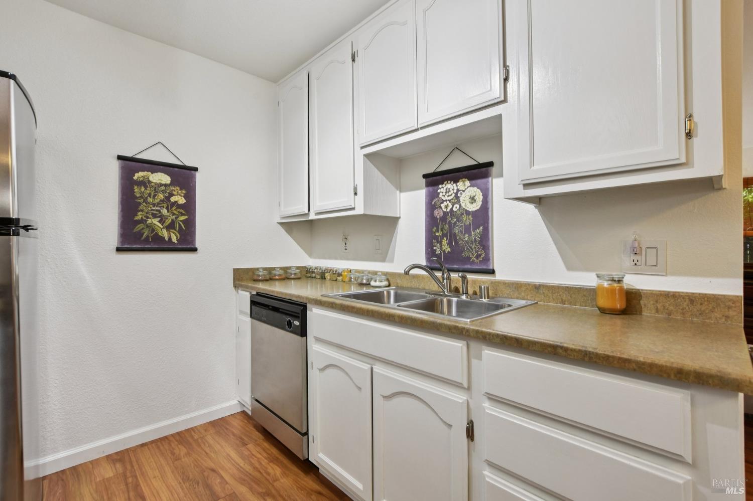 1801 Marshall Road, Unit 401 Vacaville, CA 95687 - Photo 8 of 20 a kitchen with granite countertop white cabinets and a sink