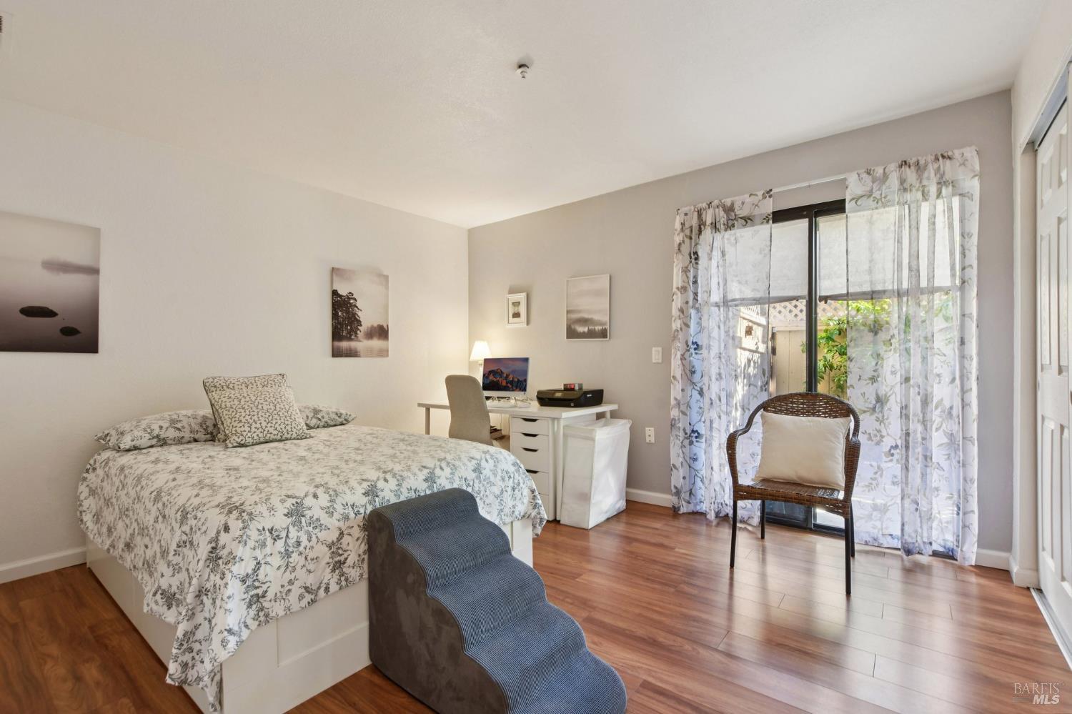 1801 Marshall Road, Unit 401 Vacaville, CA 95687 - Photo 9 of 20 a bedroom with a bed and wooden floor