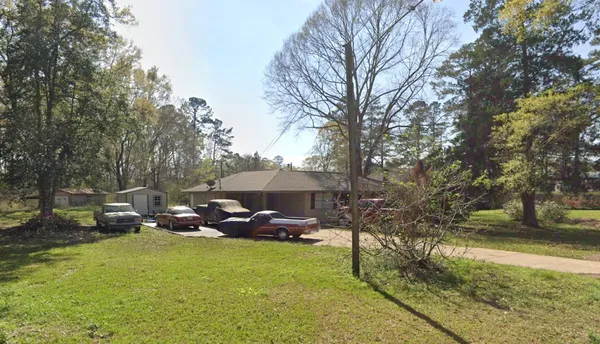 a backyard of a house with table and chairs