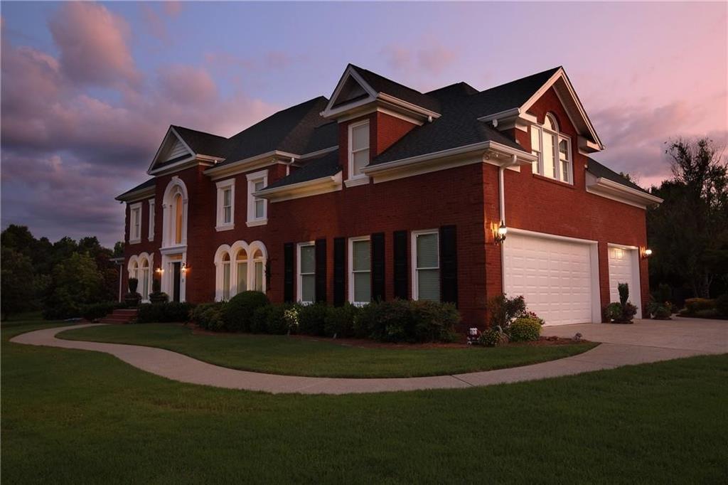 a front view of house with yard and green space