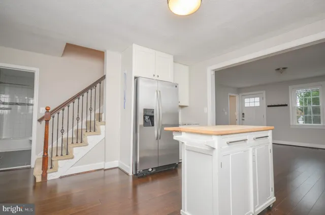 a kitchen with granite countertop a sink and steel appliances