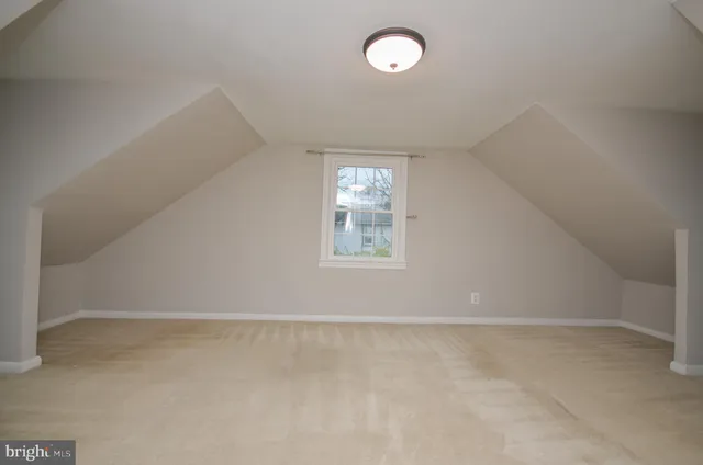 an empty room with windows and entrance