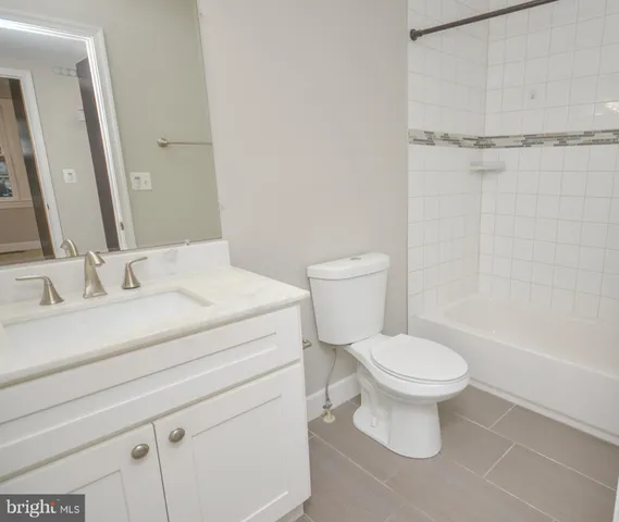 a kitchen with stainless steel appliances granite countertop a sink dishwasher a stove and a refrigerator