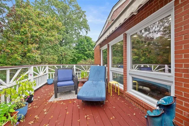 a view of a deck with two chair and wooden floor