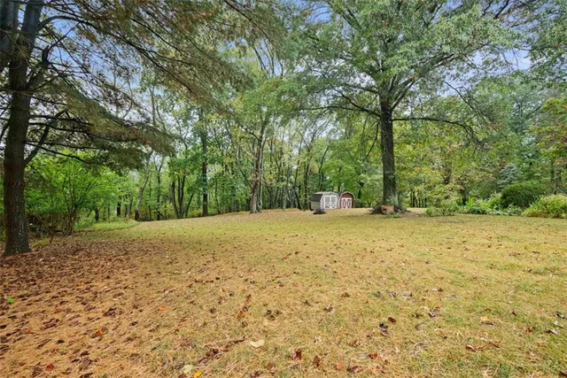 a big yard with trees in front of it