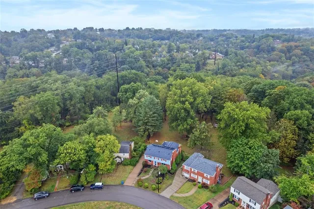 an aerial view of lake residential house with outdoor space and trees
