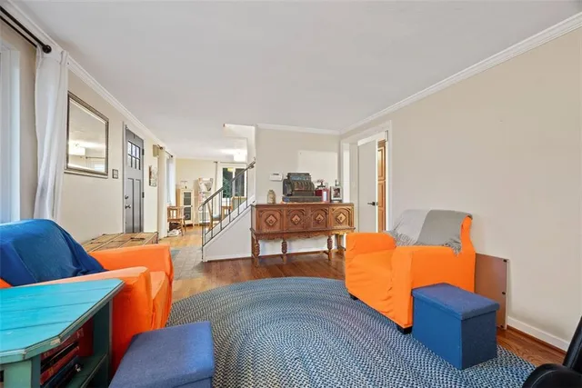 a living room with furniture and a dining table