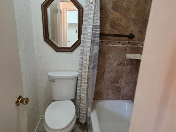 a white toilet sitting next to a bathroom sink