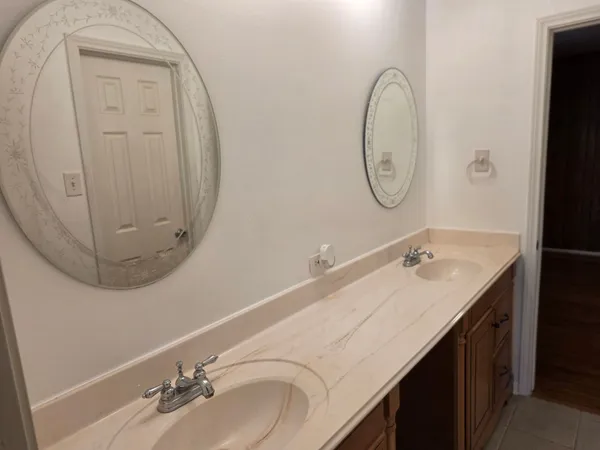 a bathroom with a double vanity sink and a mirror