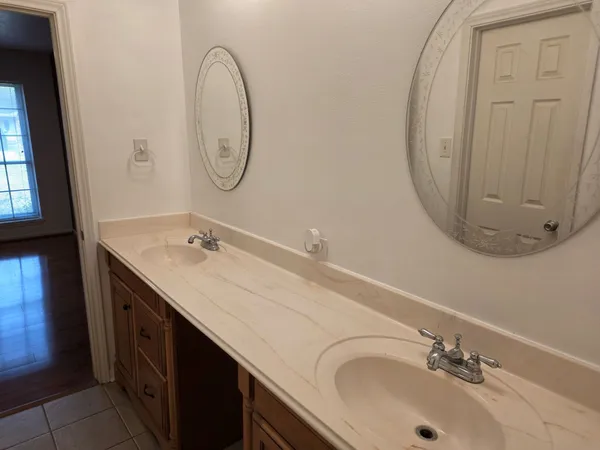 a bathroom with a double vanity sink and a mirror