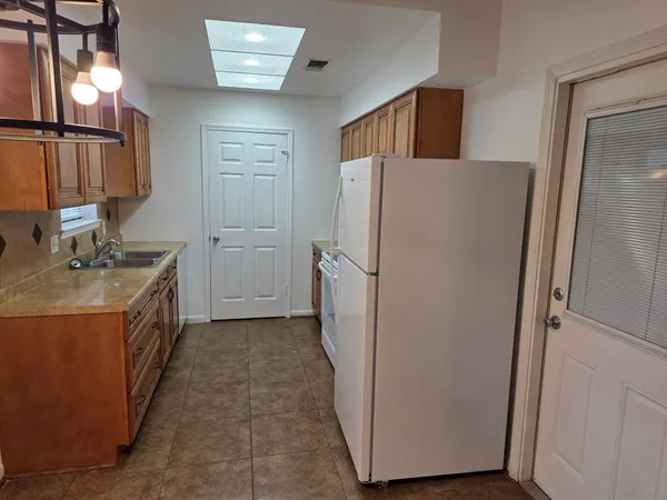 a utility room with wooden floor washer and dryer