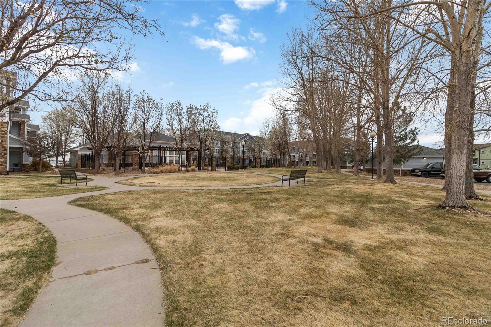5255 Memphis Street, Unit 702 Denver, CO 80239 - Photo 28 of 30 a swimming pool with trees in the background