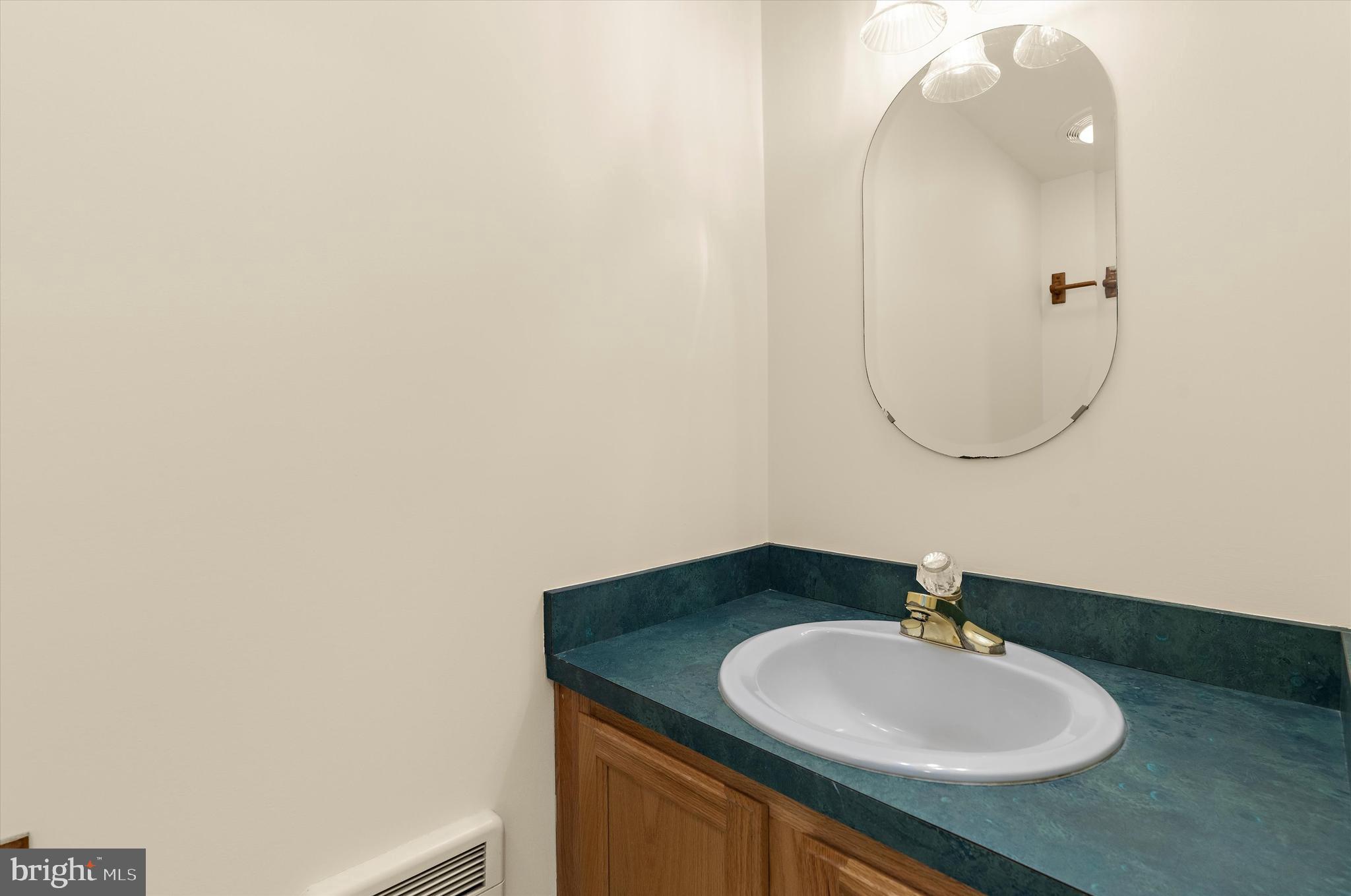 12714 Still Pond Road Still Pond, MD 21667 - Photo 41 of 62 a bathroom with a sink vanity and a mirror