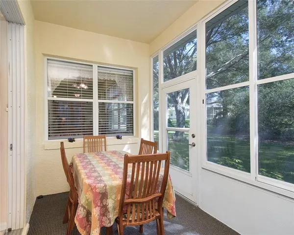 a view of a dining room with furniture large windows and wooden floor
