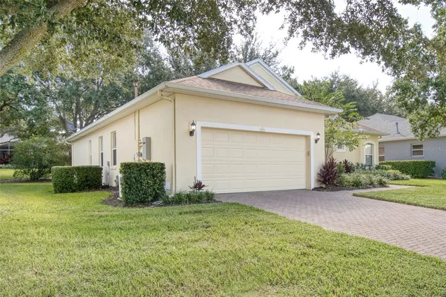a front view of a house with a yard and trees