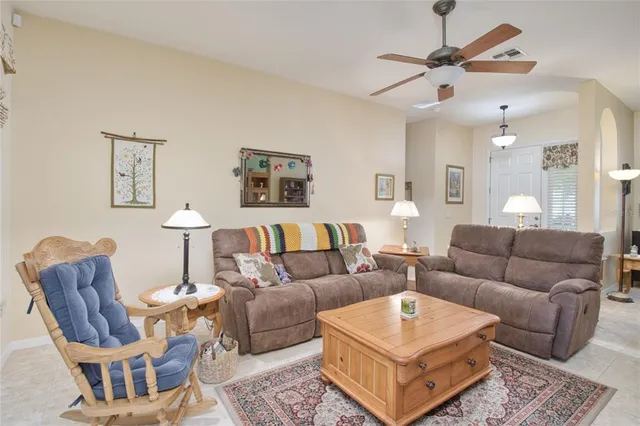 a living room with furniture a rug and a chandelier