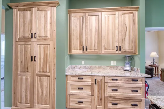 a kitchen with granite countertop white cabinets and white appliances