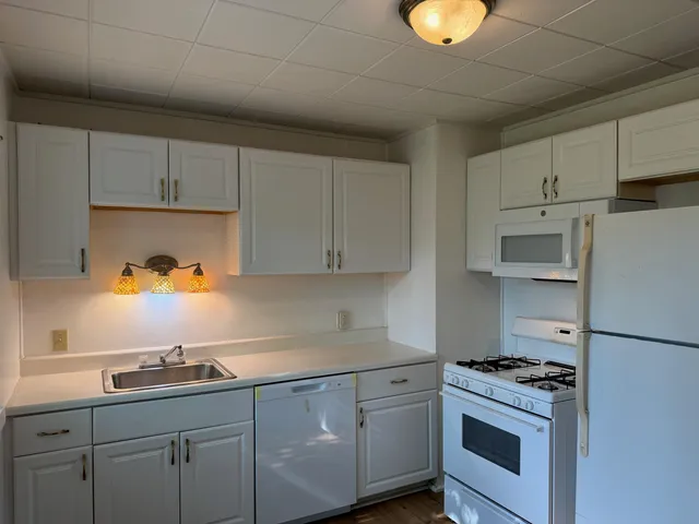 a kitchen with cabinets and appliances
