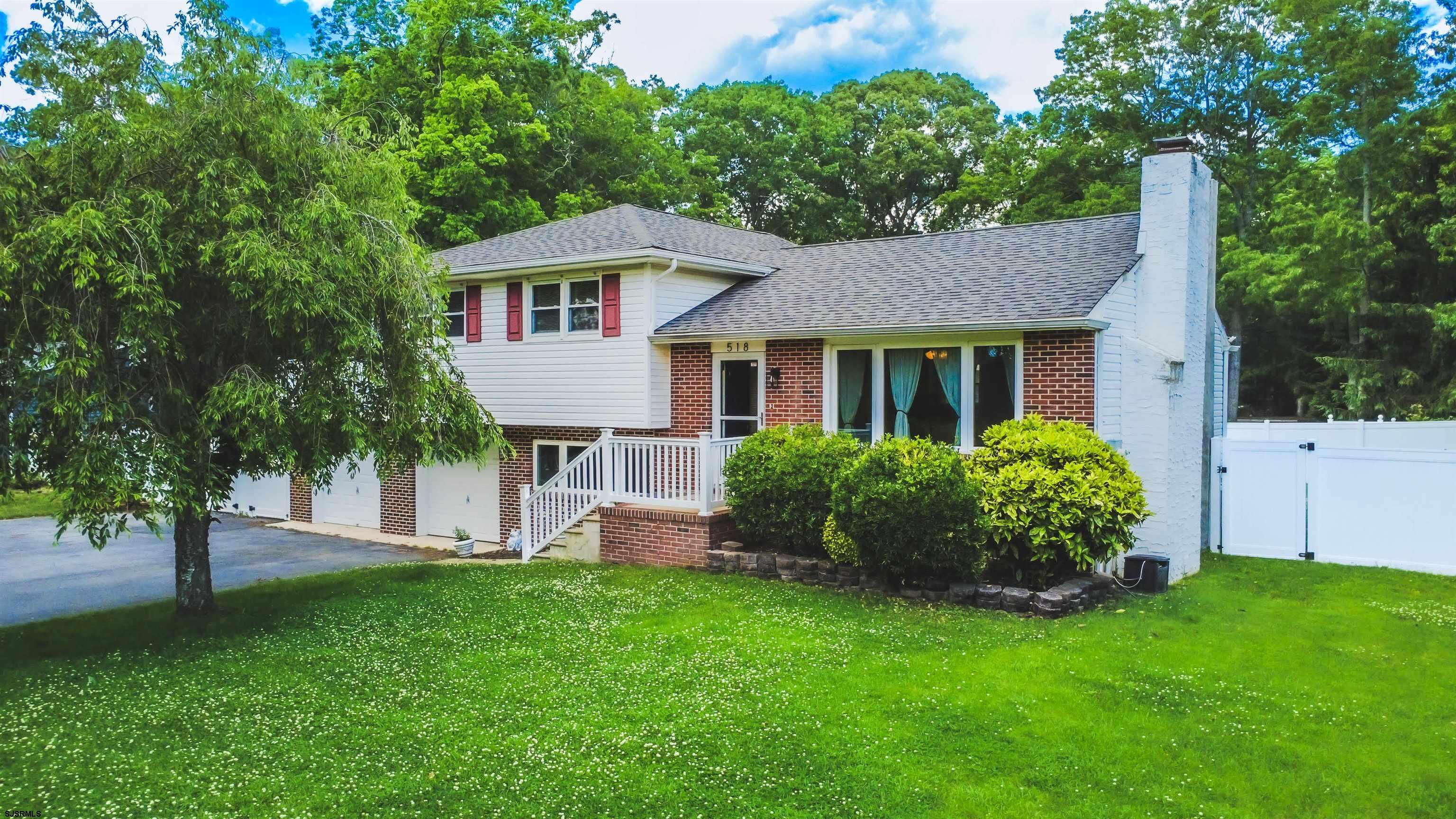 518 Delaware Avenue Absecon, NJ 08201 - Photo 2 of 38 a front view of a house with a garden