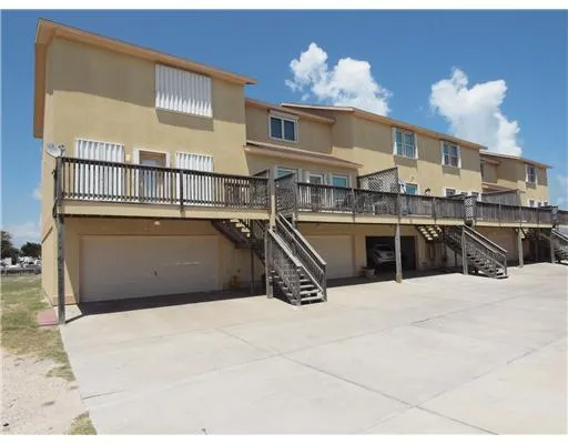 a view of a kitchen with kitchen island a sink a stove and a microwave