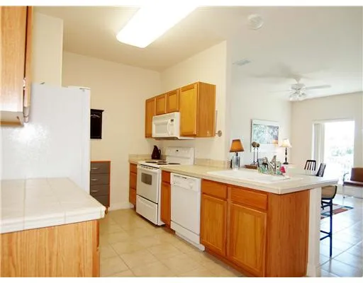a bedroom with a bed and a lamp on dresser