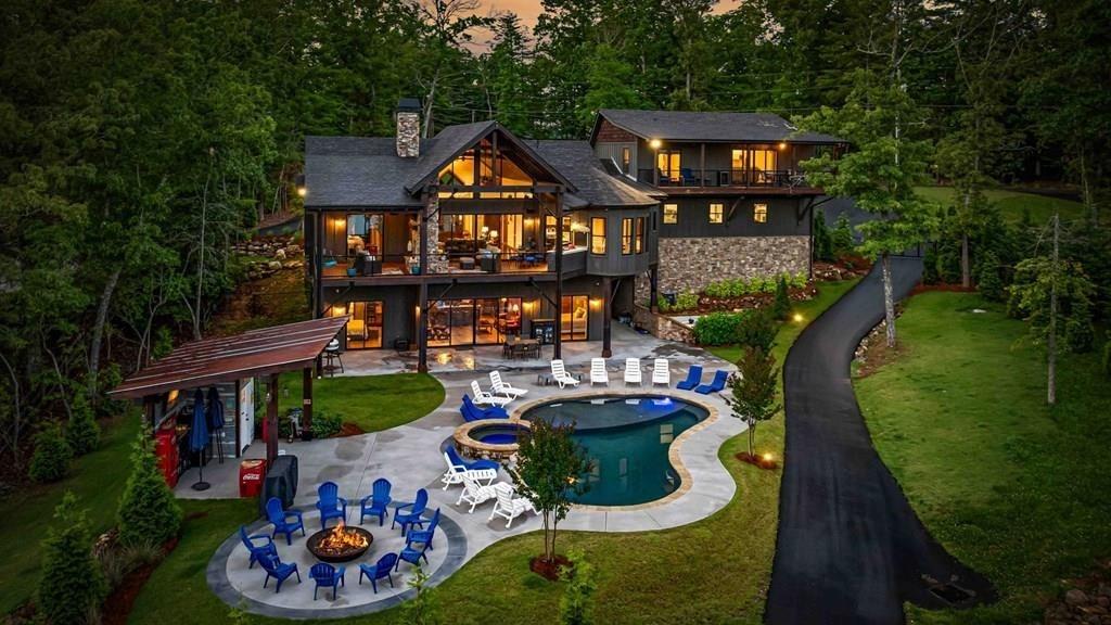 a view of a house with swimming pool and furniture
