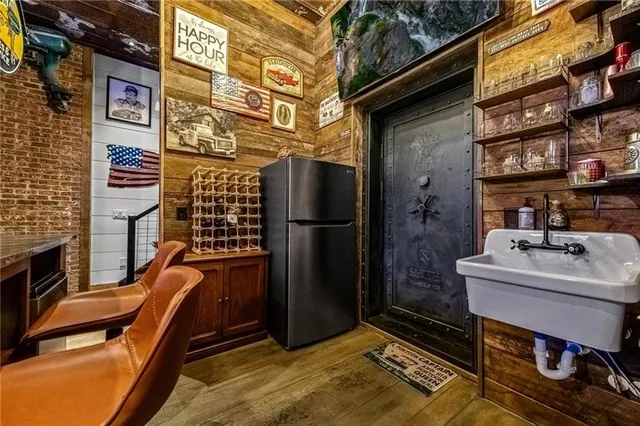 a kitchen with stainless steel appliances granite countertop a refrigerator a stove and a sink