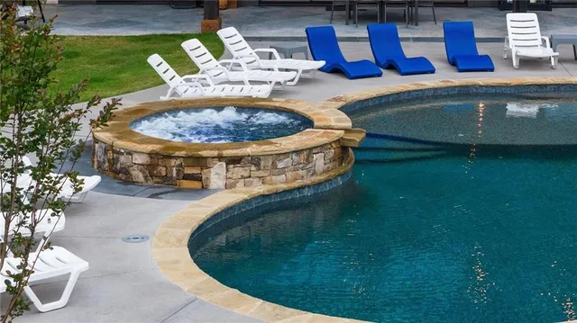 a view of a swimming pool with a yard