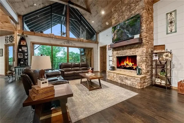 a living room with furniture flat screen tv and a fireplace