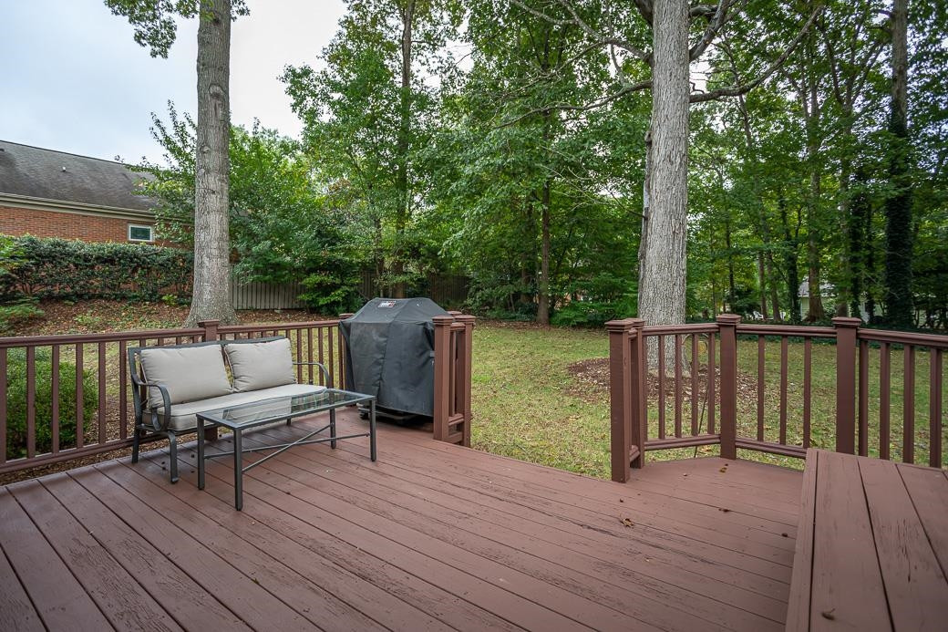 8716 Mariner Drive Raleigh, NC 27615 - Photo 25 of 26 Large deck and wooded views to a spacious rear yard.