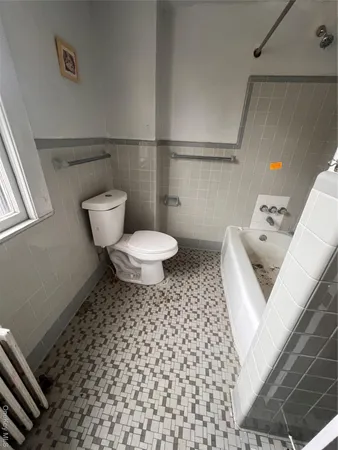 a bathroom with a toilet and a shower
