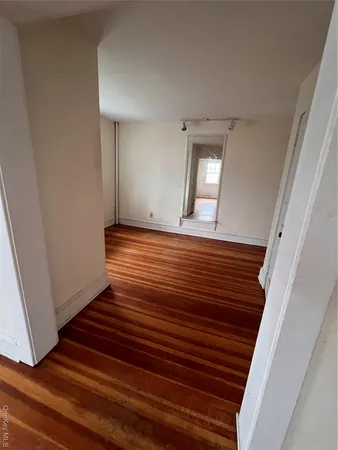 a view of a room with wooden floor and staircase