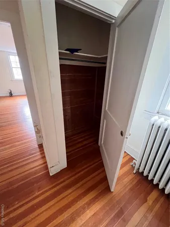 a view of a hallway with wooden floor and stairs