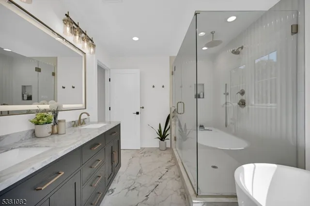 a bathroom with a granite countertop sink mirror and toilet