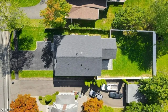 an aerial view of a house with swimming pool garden and patio