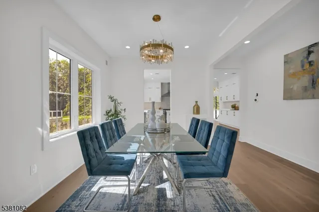 a view of a dining room with furniture wooden floor and a chandelier