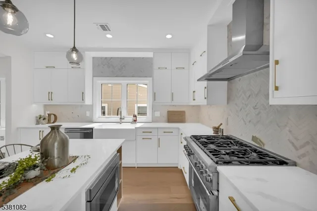 a kitchen with a sink stove and cabinets