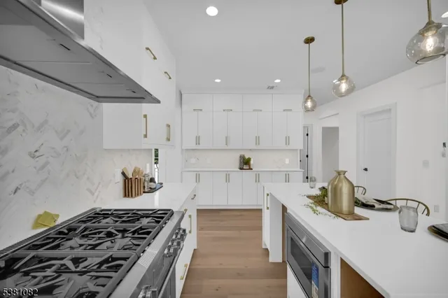 a kitchen with a stove a sink and a refrigerator